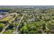 An aerial view showcases a charming neighborhood nestled among green trees and community recreational fields at 623 Oakgrove Dr, Graham, NC 27253