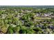 An aerial view highlights a neighborhood near community fields, with houses among lush trees and winding roads at 623 Oakgrove Dr, Graham, NC 27253