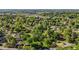 Neighborhood aerial view showing houses surrounded by lush green trees and glimpses of community buildings at 623 Oakgrove Dr, Graham, NC 27253