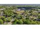 Aerial shot showcases a community with winding roads, mature trees, and recreational fields in the distance at 623 Oakgrove Dr, Graham, NC 27253