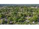 A community aerial view shows houses nestled in green trees, with a water tower visible in the distance at 623 Oakgrove Dr, Graham, NC 27253