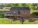 This brick house boasts a spacious deck, offering an ideal setting for outdoor relaxation and gatherings at 623 Oakgrove Dr, Graham, NC 27253