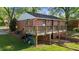Brick home showcasing a spacious deck with wooden railing, perfect for outdoor entertaining or relaxing at 623 Oakgrove Dr, Graham, NC 27253