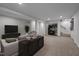 A finished basement featuring living area with modern furniture, shelving and neutral carpet at 623 Oakgrove Dr, Graham, NC 27253