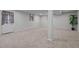 Finished basement space provides options for customization with neutral paint, carpet and a window at 623 Oakgrove Dr, Graham, NC 27253