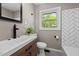 Updated bathroom features a modern vanity, black hardware, and beautiful white subway tile at 623 Oakgrove Dr, Graham, NC 27253