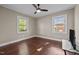 This cozy bedroom is filled with natural light from its large windows and features a ceiling fan at 623 Oakgrove Dr, Graham, NC 27253