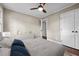 Bedroom featuring a ceiling fan, closet, a stylish cabinet, and a comfortable bed and pillows at 623 Oakgrove Dr, Graham, NC 27253