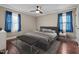 Bedroom showcasing a large bed, a gray bench, bedside tables, and blue curtains for a modern feel at 623 Oakgrove Dr, Graham, NC 27253