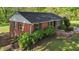 Classic brick home featuring a well-maintained lawn with meticulous landscaping and excellent natural light at 623 Oakgrove Dr, Graham, NC 27253