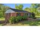 Traditional brick home showcasing meticulous landscaping, a new roof, and well-maintained exterior features at 623 Oakgrove Dr, Graham, NC 27253