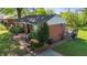 Classic brick home featuring a covered porch, a cozy deck and pristine landscaping at 623 Oakgrove Dr, Graham, NC 27253