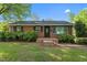 Charming brick home with a manicured lawn and inviting front entrance at 623 Oakgrove Dr, Graham, NC 27253