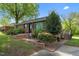 Inviting brick home with manicured landscaping, brick entry and stairs at 623 Oakgrove Dr, Graham, NC 27253