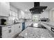 Bright kitchen features updated white cabinets, granite countertops, modern backsplash, and newer appliances at 623 Oakgrove Dr, Graham, NC 27253