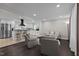 Open-concept living room and kitchen with stainless steel appliances and bar seating at 623 Oakgrove Dr, Graham, NC 27253