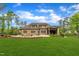 This brick home offers a backyard with a pool, outdoor kitchen, lush landscaping, and ample space for entertaining and recreation at 628 Carolina Crossings Dr, Apex, NC 27523