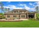 A home with a serene backyard featuring a swimming pool, outdoor kitchen, manicured lawn, and lush greenery, perfect for relaxing at 628 Carolina Crossings Dr, Apex, NC 27523