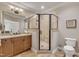 Bathroom with double sink vanity, granite countertops, corner glass shower, and tile floors at 628 Carolina Crossings Dr, Apex, NC 27523