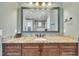 Bathroom vanity with granite countertop and a framed mirror reflecting the glass enclosed shower and the commode at 628 Carolina Crossings Dr, Apex, NC 27523