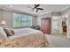 Bedroom with a ceiling fan, shuttered windows, carpet flooring and a wooden wardrobe at 628 Carolina Crossings Dr, Apex, NC 27523