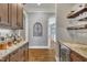 Butler's Pantry with hardwood floors, granite countertops, wine cooler, and glass racks at 628 Carolina Crossings Dr, Apex, NC 27523