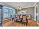 Elegant dining room with hardwood floors, chandelier and large windows at 628 Carolina Crossings Dr, Apex, NC 27523