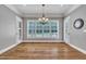 Dining room featuring hardwood floors, windows, and modern chandelier lighting at 628 Carolina Crossings Dr, Apex, NC 27523