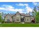 Beautiful two-story stone and brick home with a manicured lawn and inviting double door entrance at 628 Carolina Crossings Dr, Apex, NC 27523