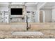 Close up of the kitchen sink and granite countertops with view of the living area at 628 Carolina Crossings Dr, Apex, NC 27523