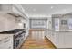 Spacious open concept kitchen features a kitchen island and stone backsplash at 628 Carolina Crossings Dr, Apex, NC 27523