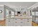 Kitchen island with granite counters overlooking the living room and stainless steel appliances at 628 Carolina Crossings Dr, Apex, NC 27523