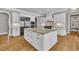 Spacious kitchen with a center island, custom cabinets, and stainless steel appliances at 628 Carolina Crossings Dr, Apex, NC 27523