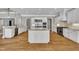 Large kitchen with double islands, granite countertops, and stainless steel appliances at 628 Carolina Crossings Dr, Apex, NC 27523