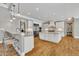 Open gourmet kitchen featuring custom cabinets, center island, and stainless steel appliances at 628 Carolina Crossings Dr, Apex, NC 27523