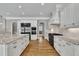 Spacious kitchen features granite countertops, white cabinets, and stainless steel appliances at 628 Carolina Crossings Dr, Apex, NC 27523