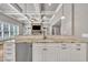 Kitchen bar with granite countertops, white cabinets, and stainless-steel dishwasher at 628 Carolina Crossings Dr, Apex, NC 27523