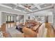 Spacious living room featuring coffered ceilings and hardwood floors open to the bright kitchen at 628 Carolina Crossings Dr, Apex, NC 27523