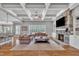 Comfortable living room features a stone fireplace, built-in shelving, and coffered ceilings at 628 Carolina Crossings Dr, Apex, NC 27523