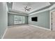 Large main bedroom features tray ceilings, neutral carpet, and a view of the backyard at 628 Carolina Crossings Dr, Apex, NC 27523