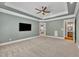Spacious main bedroom boasts tray ceilings and ensuite bathroom access, and view to backyard at 628 Carolina Crossings Dr, Apex, NC 27523