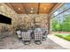 Enjoy outdoor dining in this covered patio with stone fireplace, a fully equipped kitchen, and ample seating at 628 Carolina Crossings Dr, Apex, NC 27523