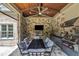 Enjoy this outdoor kitchen and dining area with a stone fireplace, tv, and grill, perfect for entertaining and relaxation at 628 Carolina Crossings Dr, Apex, NC 27523