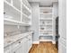 Pantry with white shelving and granite countertops for storage at 628 Carolina Crossings Dr, Apex, NC 27523