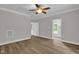 Spacious bedroom with ceiling fan, grey walls, white trim, and modern flooring at 701 Oakwood St, Mebane, NC 27302