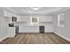 Bright kitchen with white cabinets, stainless appliances, and wood flooring, a chef's dream at 701 Oakwood St, Mebane, NC 27302
