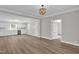 Bright and airy living room showcasing wood floors that flow into the kitchen at 701 Oakwood St, Mebane, NC 27302