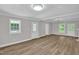 Open living room with fresh gray paint, white trim, and modern vinyl plank flooring at 701 Oakwood St, Mebane, NC 27302