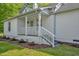 Inviting porch with white railings and landscaping, perfect for relaxing outdoors at 701 Oakwood St, Mebane, NC 27302