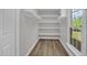 Well-organized walk-in closet with ample shelving and modern flooring at 701 Oakwood St, Mebane, NC 27302
